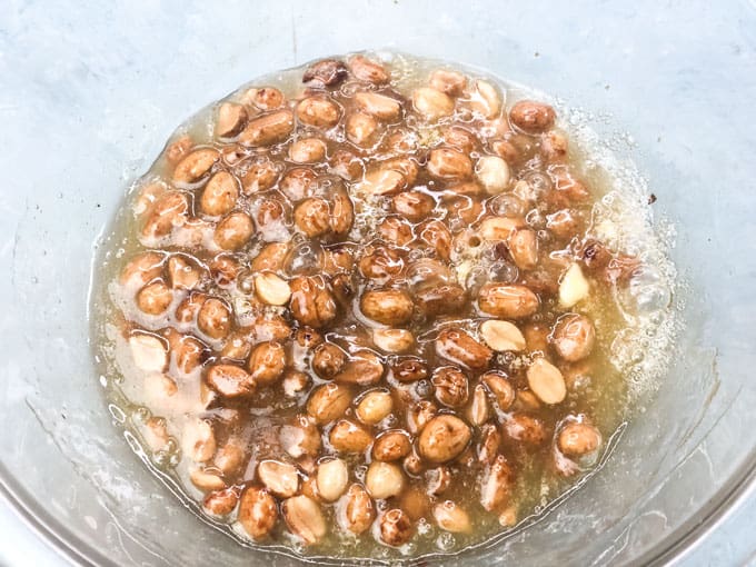 melted microwave peanut brittle in glass bowl