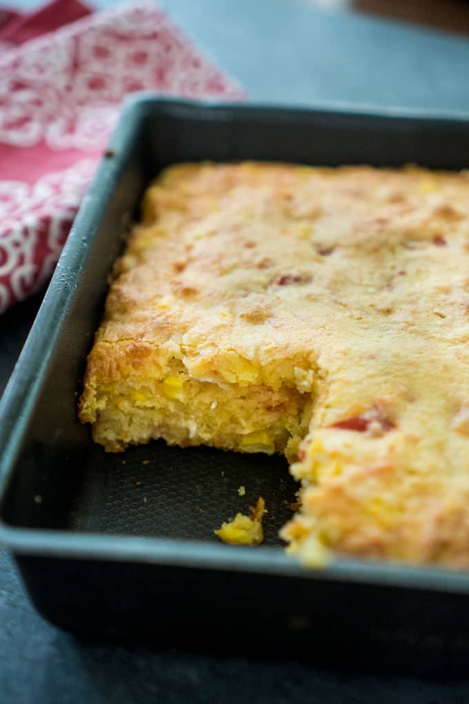 close up of Cornbread in baking pan with one piece missing