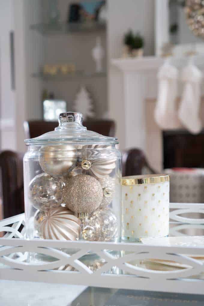 A vase with ornaments inside with living room in background