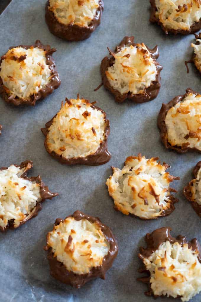 chocolate dipped  Coconut Macaroons on parchment paper