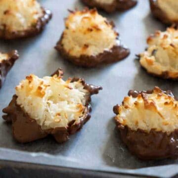 chocolate dipped coconut macaroons on baking sheet