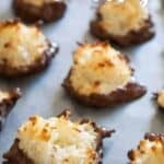 chocolate dipped coconut macaroons on baking sheet