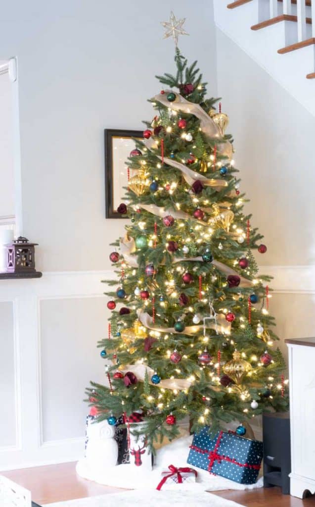 A christmas tree in corner of a room