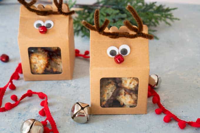 two reindeer treat boxes made from craft paper, pipe cleaner, red small bell, and craft eyes