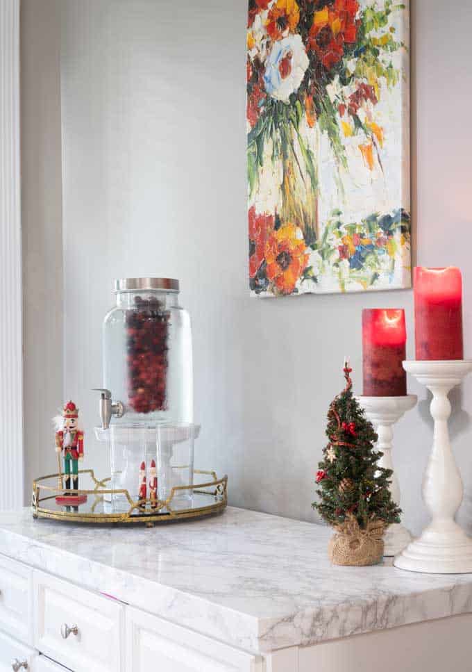 marble counter with red candles and drink dispenser and nutcracker