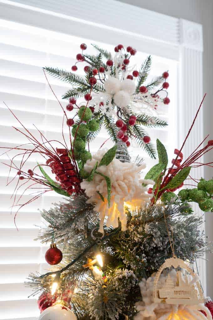 top of a christmas tree with fake berries