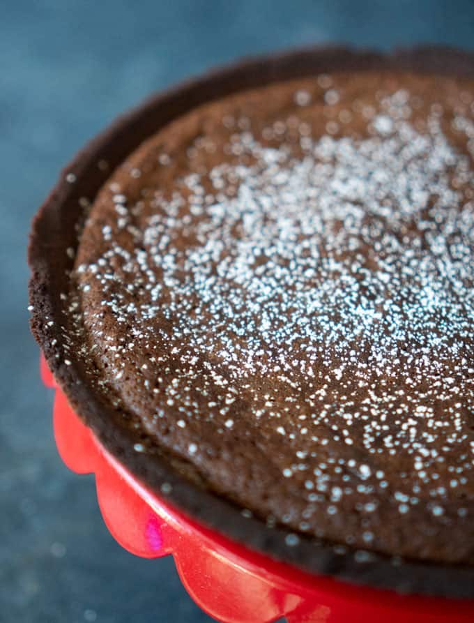 close up of hot fudge pie on red cake stand