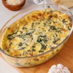 baked spinach artichoke dip in glass baking dish