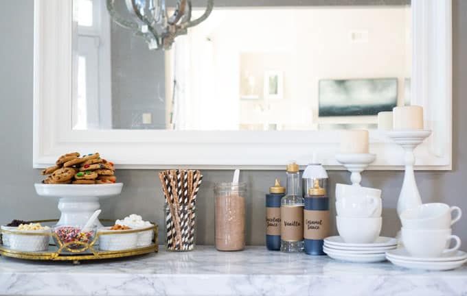 hot chocolate bar with toppings on marble counter