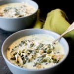 instant pot keto chicken spinach soup in light blue bowls with spoon and green napkin