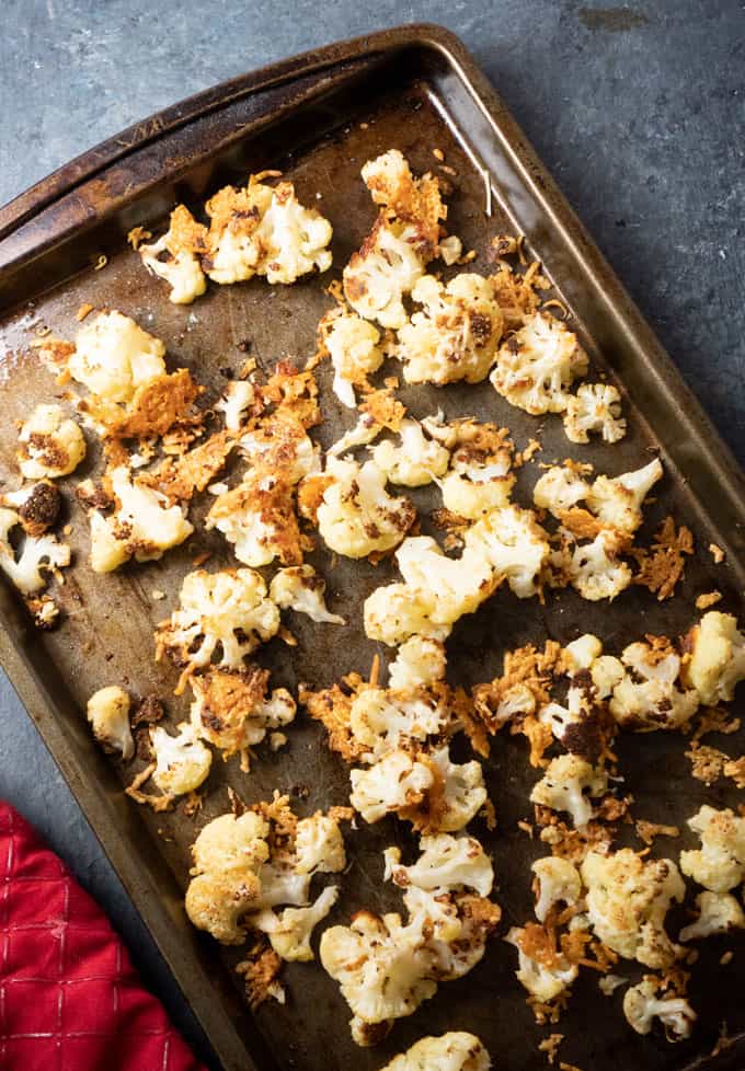 overhead view of parmesan roasted cauliflower on baking sheet