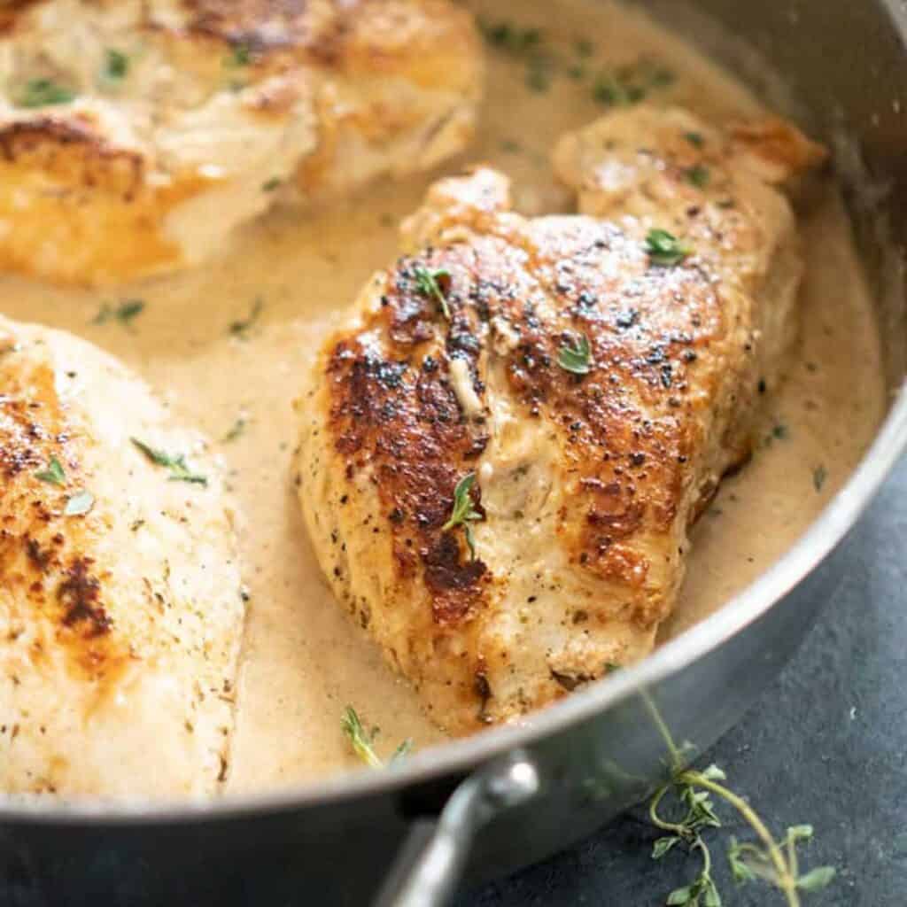 garlic herb chicken with sauce in skillet