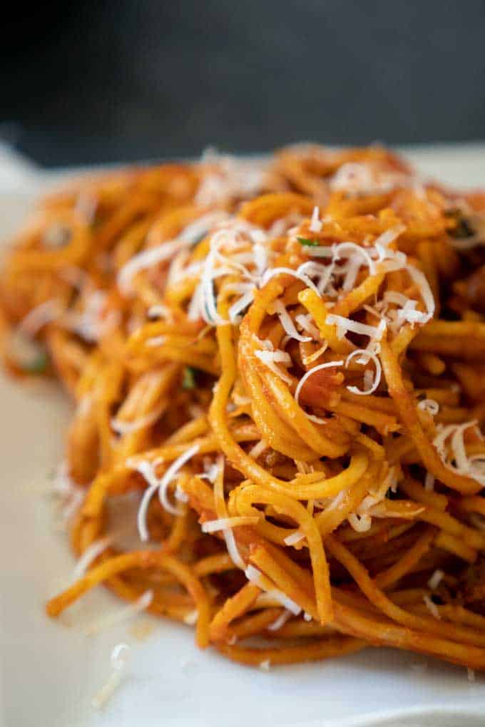 Close up of instant pot spaghetti with shredded parmesan cheese