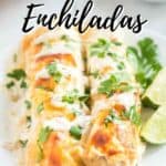 two white chicken enchiladas on white plate with lime wedges