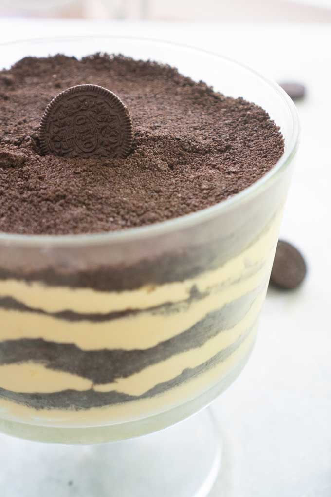 dirt cake with oreo on top in glass trifle dish