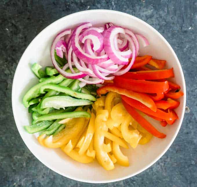 bell peppers and onion chopped in white bowl