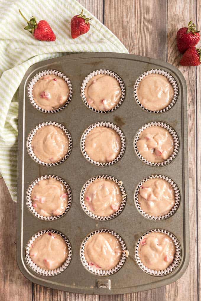 strawberry muffin batter in muffin pan