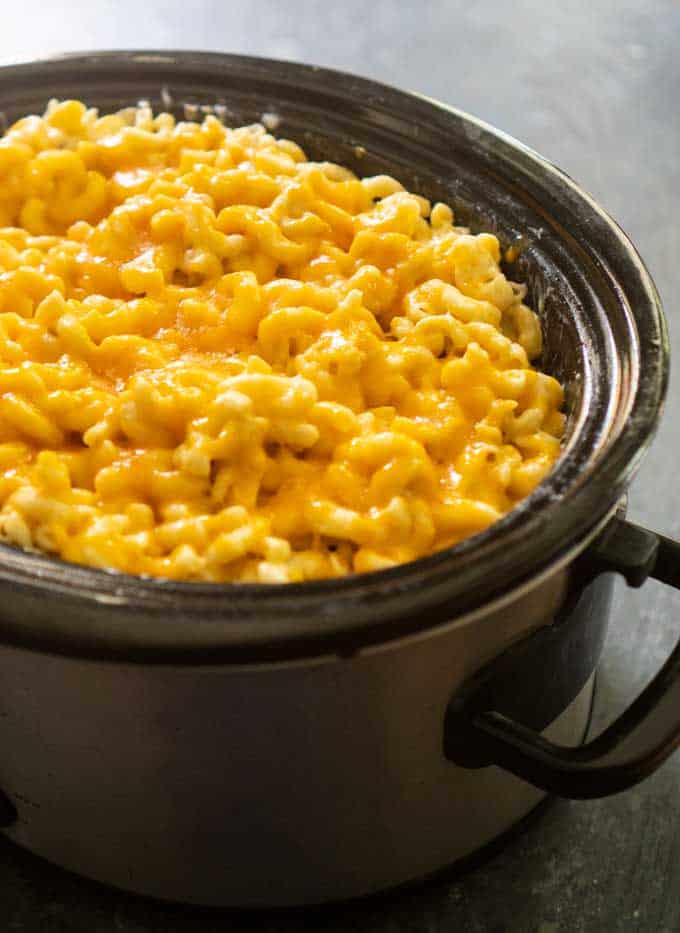 homemade mac and cheese in a black slow cooker crock pot