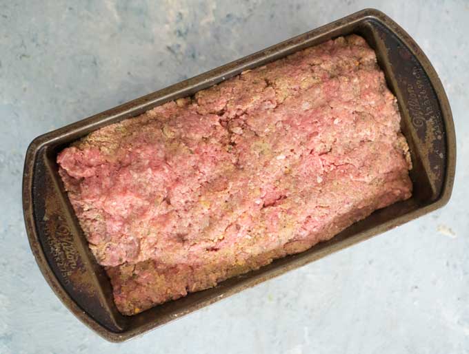 uncooked cheese stuffed meatloaf in baking pan