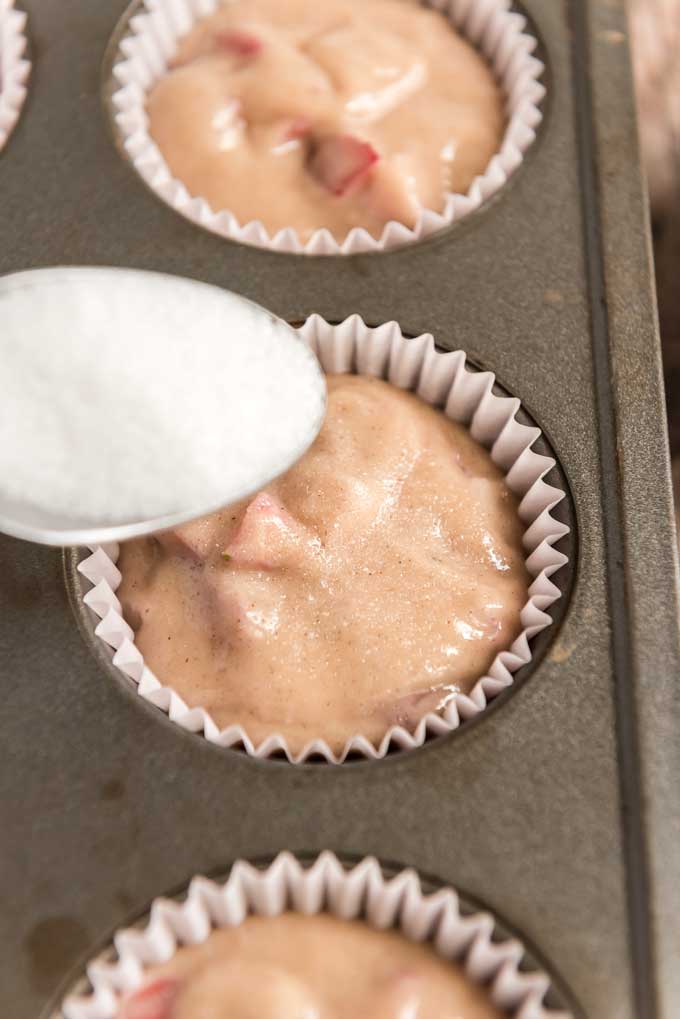 sprinkling sugar on muffin batter tops before baking strawberry muffins