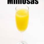 mimosa in champagne flute on white marble with Ultimate guide to mimosas text overlay