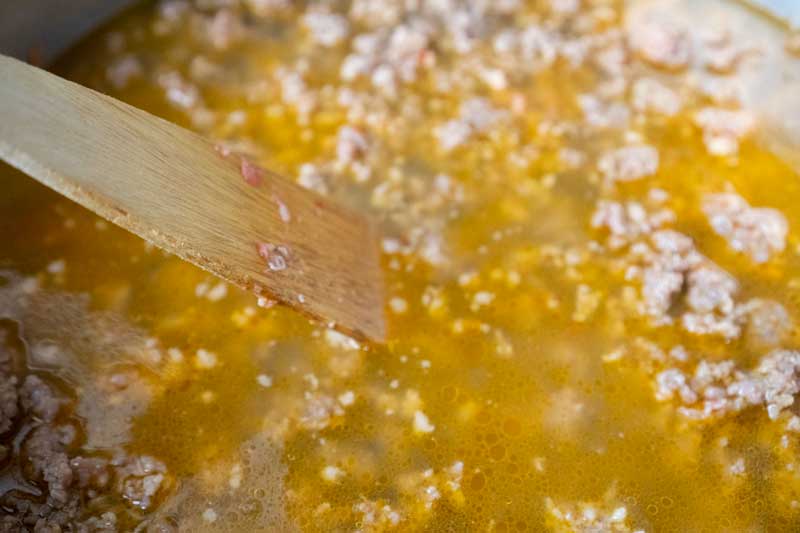 deglazing a pan with chicken broth