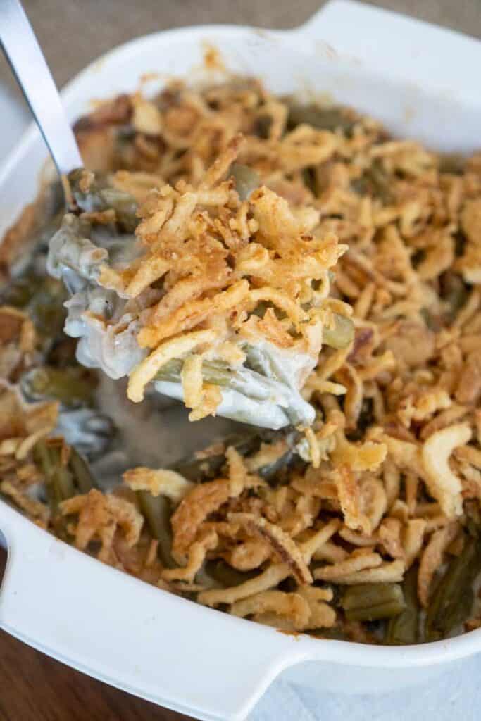 classic green bean casserole with crunchy onions in white dish