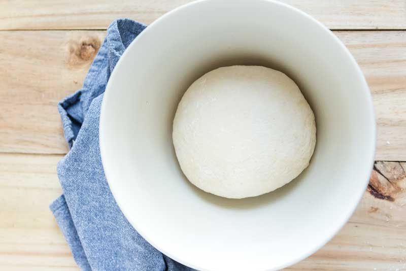 naan dough rolled into ball in bowl
