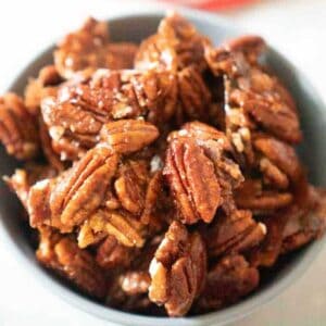 close up of spicy candied pecans in bowl