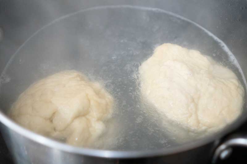 boiling pretzel dough in baking soda wash