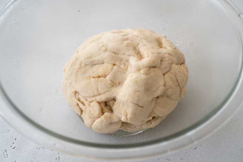 pretzel bread dough in glass bowl