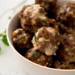 homemade meatballs in white ceramic bowl on white counter