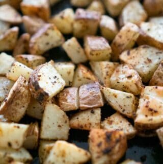 close up of diced russet potatoes with herbs after roasting