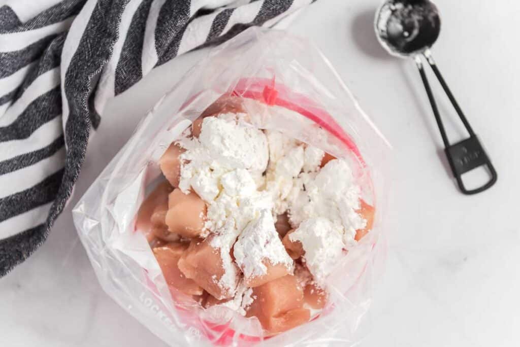 chicken breast cut into cubes in bag with cornstarch