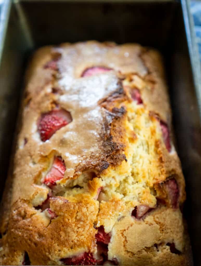 loaf of homemade strawberry bread in a loaf pan