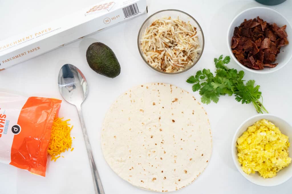 breakfast burrito ingredients on white countertop