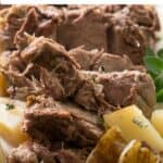 intant pot Greek leg of lamb on white platter with potatoes and text