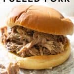 text reading slow cooker pulled pork over photo of pulled pork sandwich on crumpled wax paper