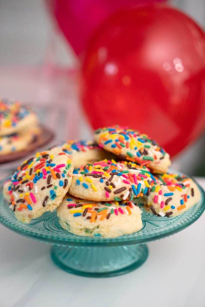 turquoise glass cake stand with sprinkled cookies on top