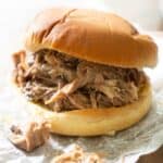 pulled pork sandwich on crumpled wax paper