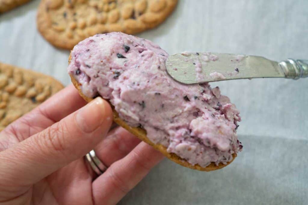 butter knife spreading frozen yogurt on breakfast biscuit