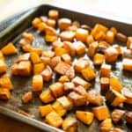 roasted diced sweet potatoes on baking sheet