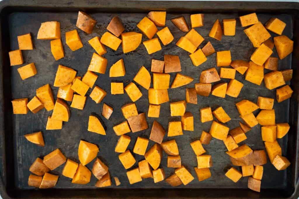 cubed sweet potatoes on baking sheet before baking