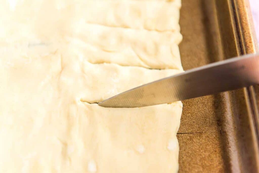 knife cutting pastry dough
