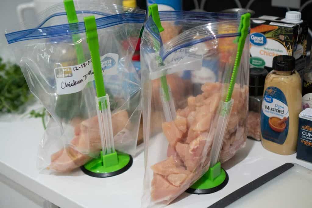freezer bags in holders with chicken inside