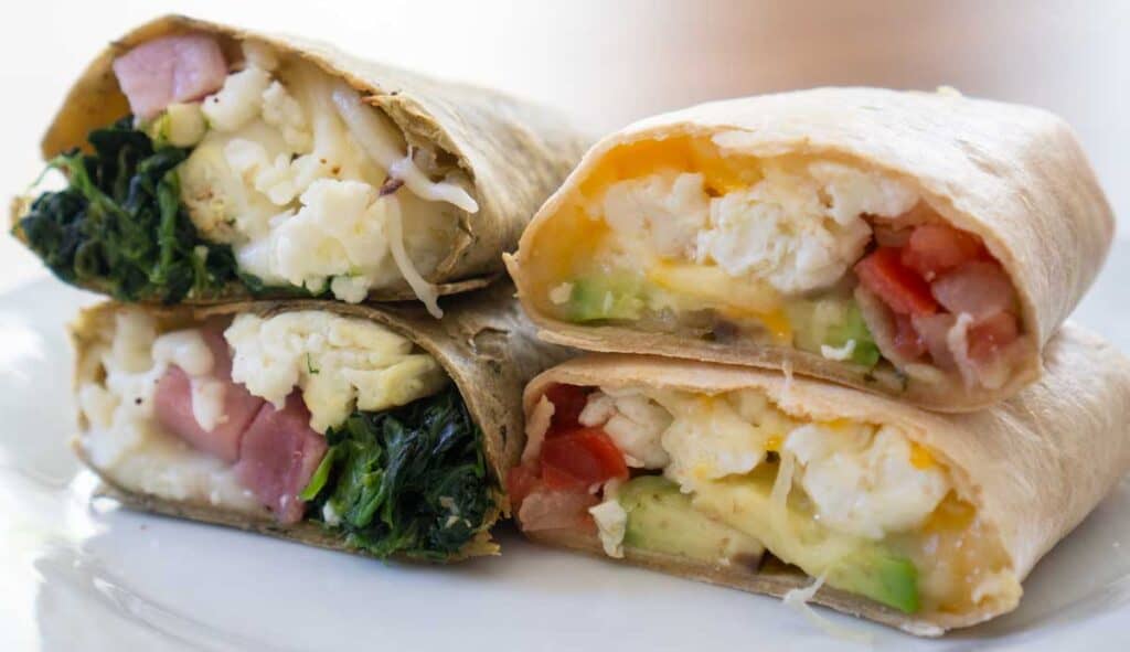 two stacks of breakfast burritos