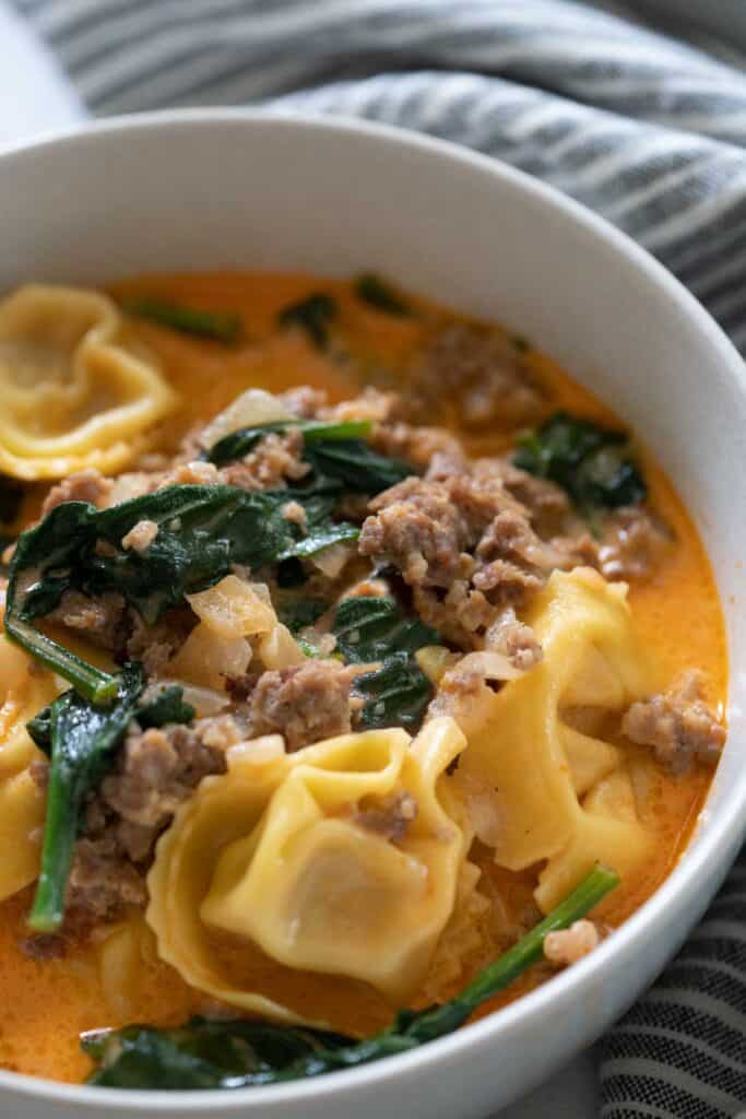 tortellini soup in white bowl