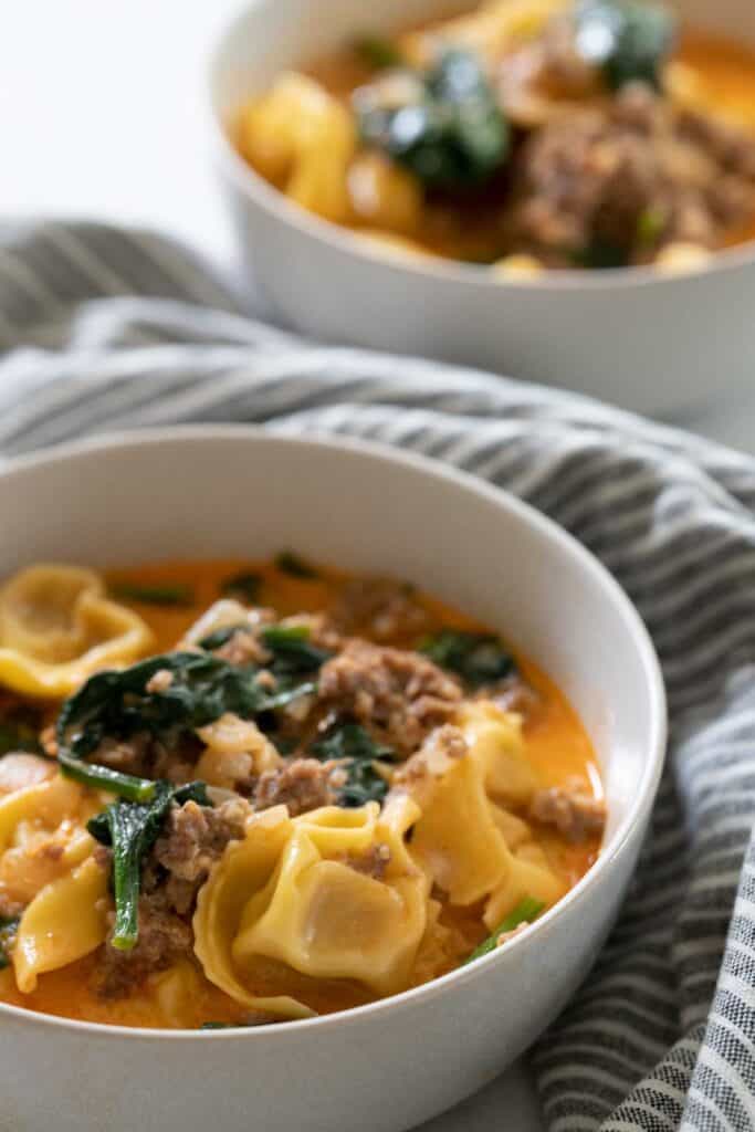 tortellini soup in white bowl