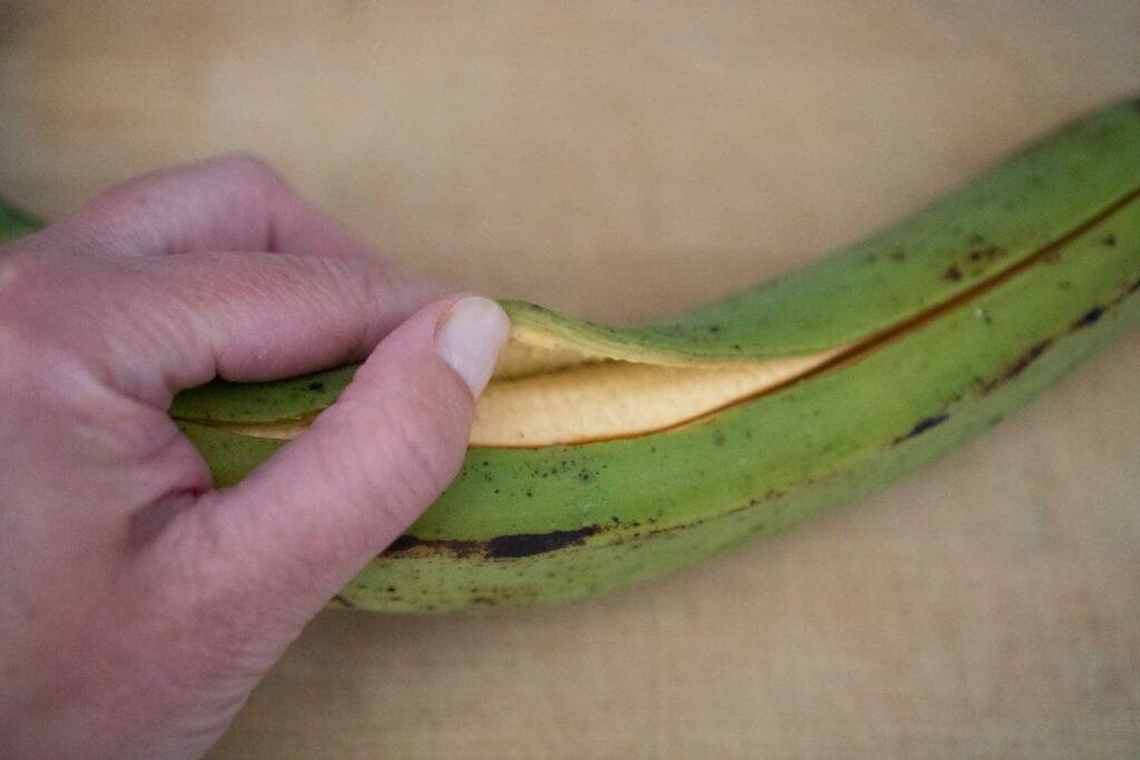 hand peeling plantain