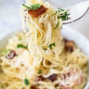 fork holding pasta carbonara